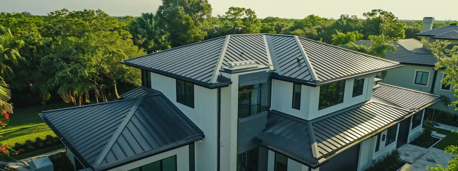 a skilled roofing contractor carefully securing sleek silver aluminum panels atop a modern florida home, ensuring a perfect blend of durability and style.