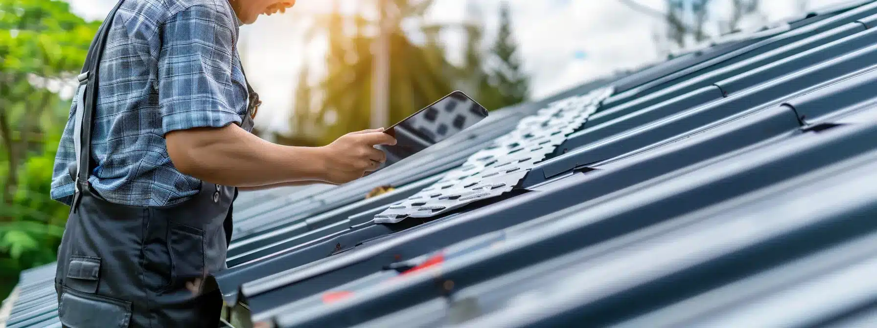 a roofing expert inspecting a metal roof with custom drainage solutions, ensuring optimal performance and longevity.